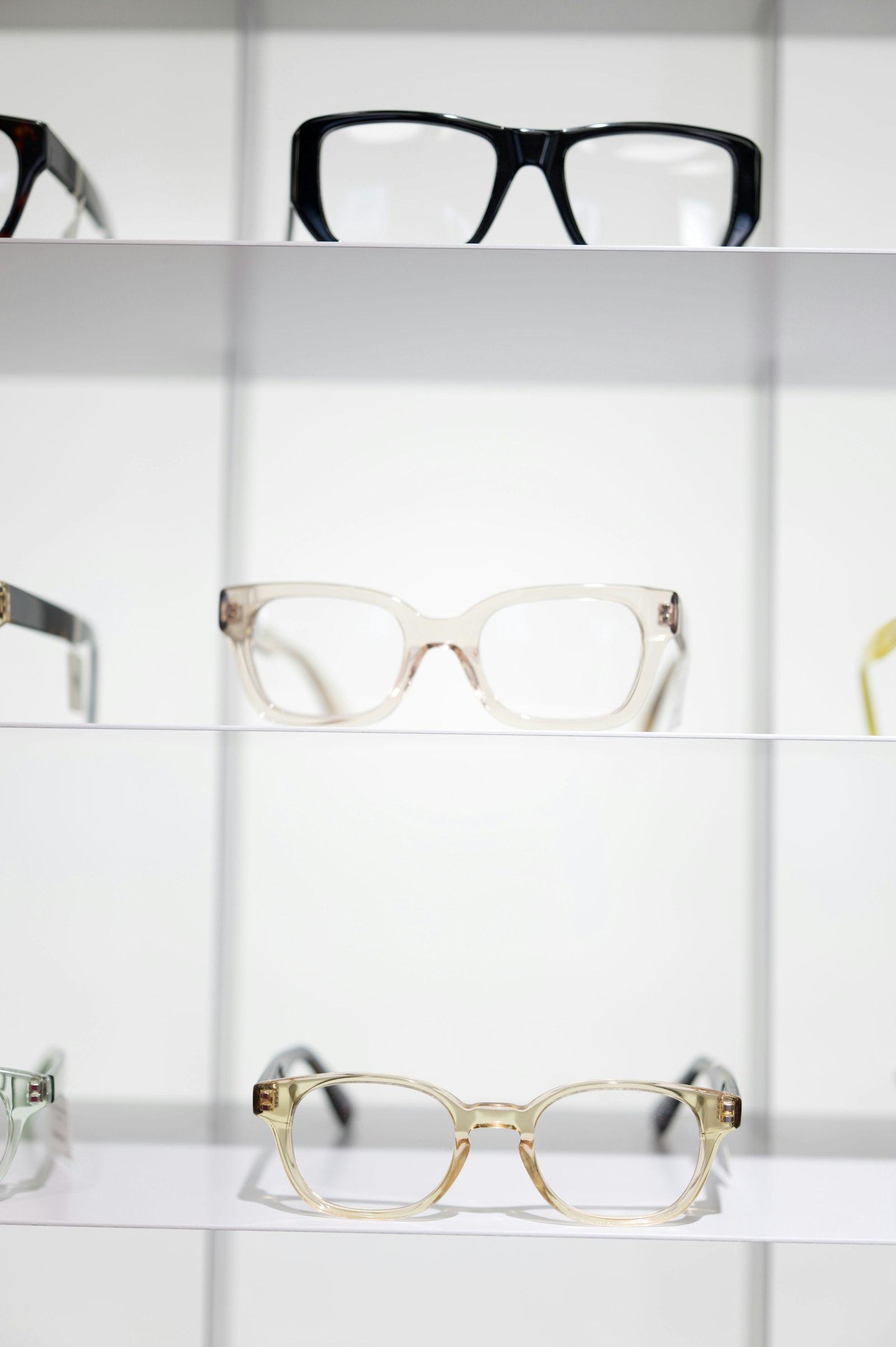 Top designer eyeglass frames displayed on a boutique shelf