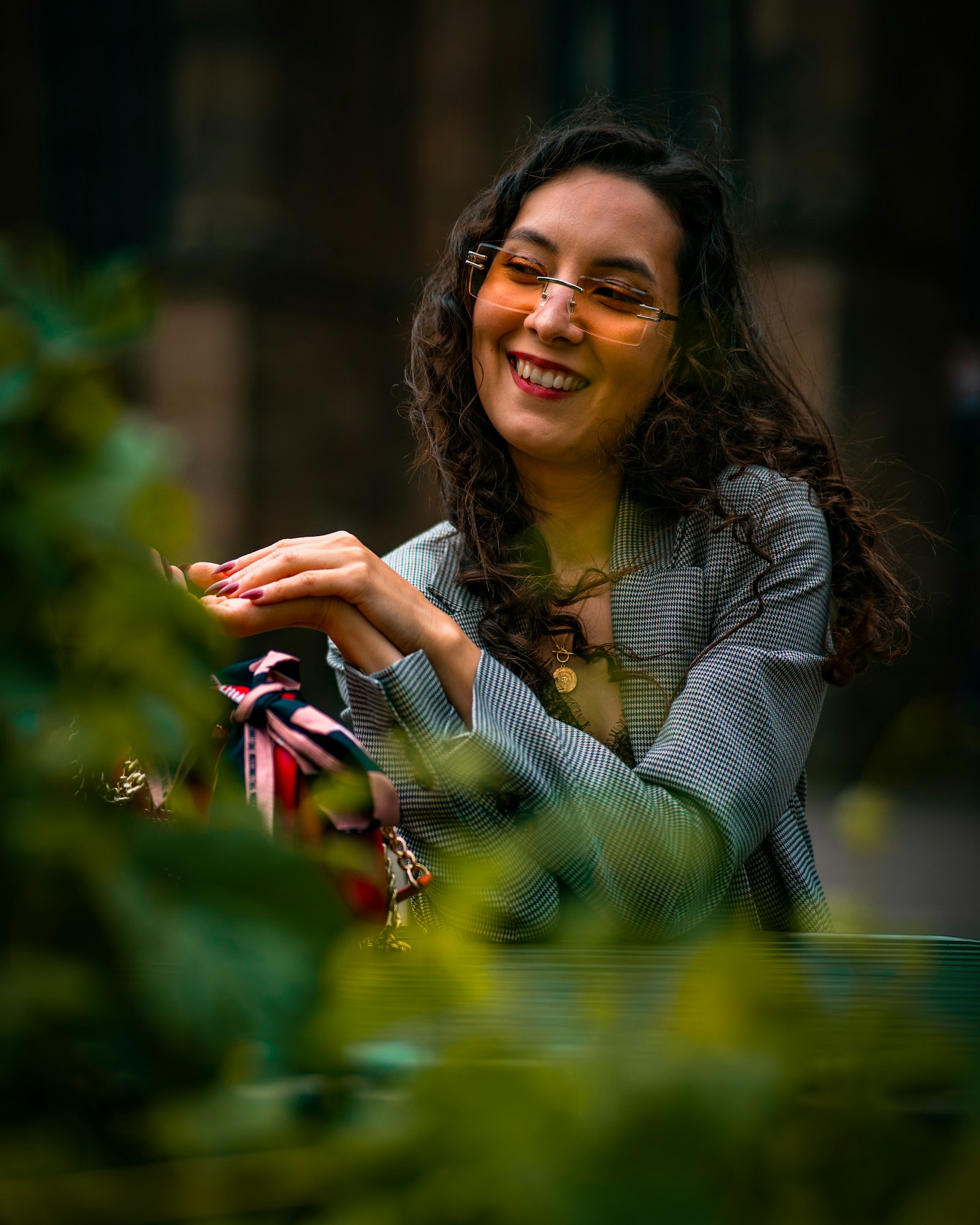 Woman wearing tinted eyewear outdoors in sunlight, representing photochromic lens performance