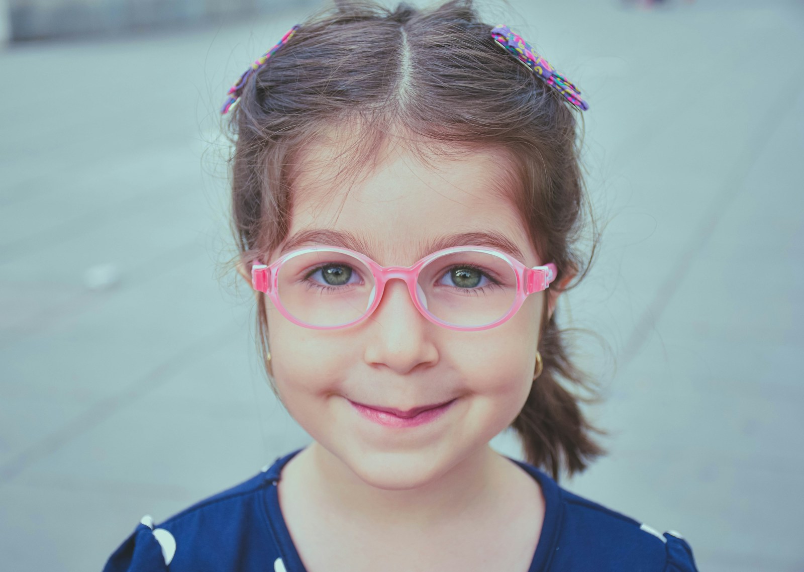 Young girl wearing glasses, representing myopia management lenses for children