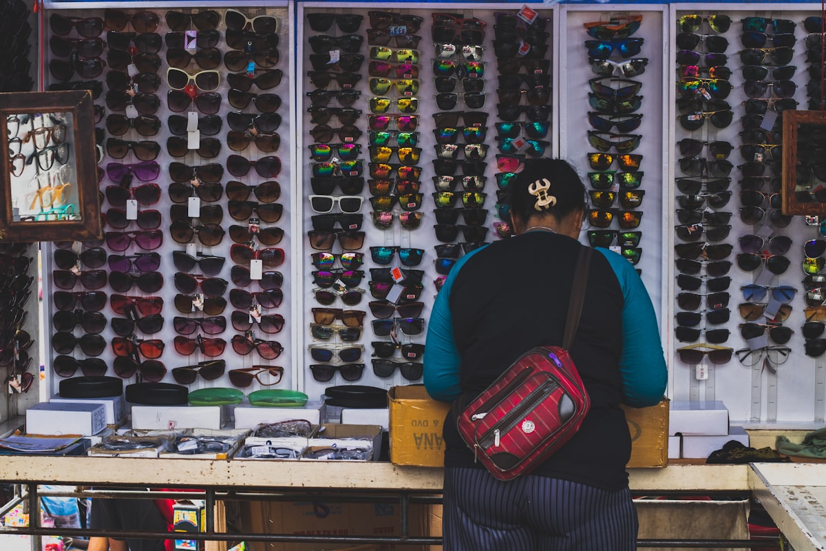 Customer browsing a designer sunglasses display in an optical store